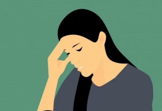Woman worrying and holding her forehead