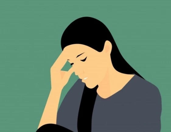 Woman worrying and holding her forehead